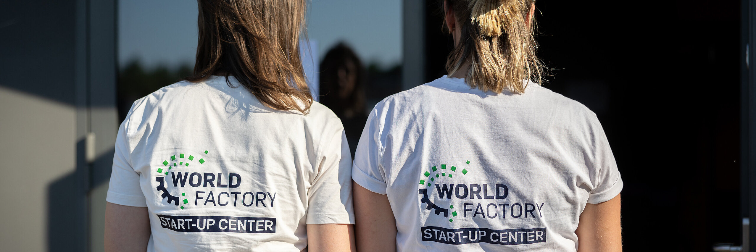 Two women with the WSC logo on the back of their T-shirts.