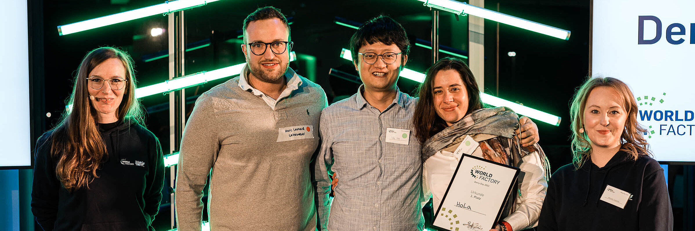 HoLa's team wins first place at WSC Demo Day 2023, standing next to WSC presenters Melusine Reimers and Michelle Twardzik.